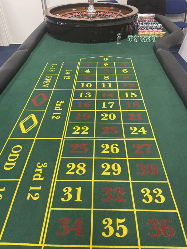 Elegant live house host in a red silk robe greeting bettors at a betting wheel showing the top BH 999 house world in Bangladesh