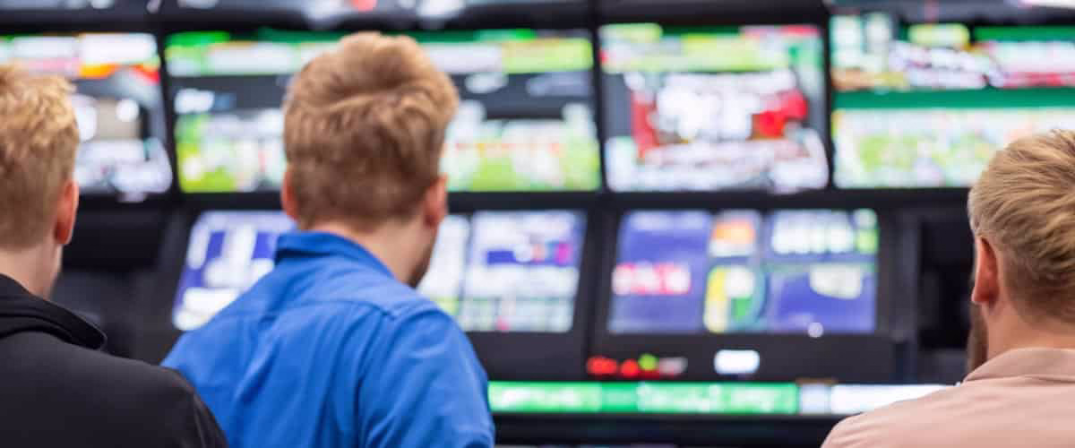 Keen Bengali punter checking live cricket betting odds on a PC using BH 999 while following a match on TV in a warm home spot