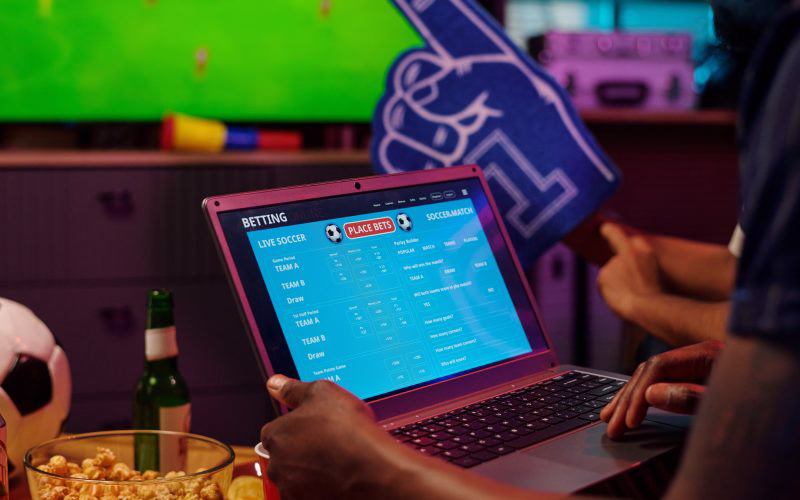 Sharp Bengali punter using a PC and mobile tool at home while watching live cricket thrills and placing bids on BH 999